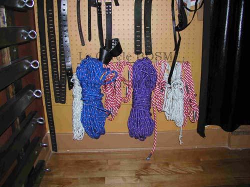 picture of the left side, bottom part of the ouside wall with the BDSM toys on it