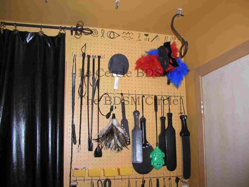picture of the top right side of the outside wall with all the BDSM toys on it